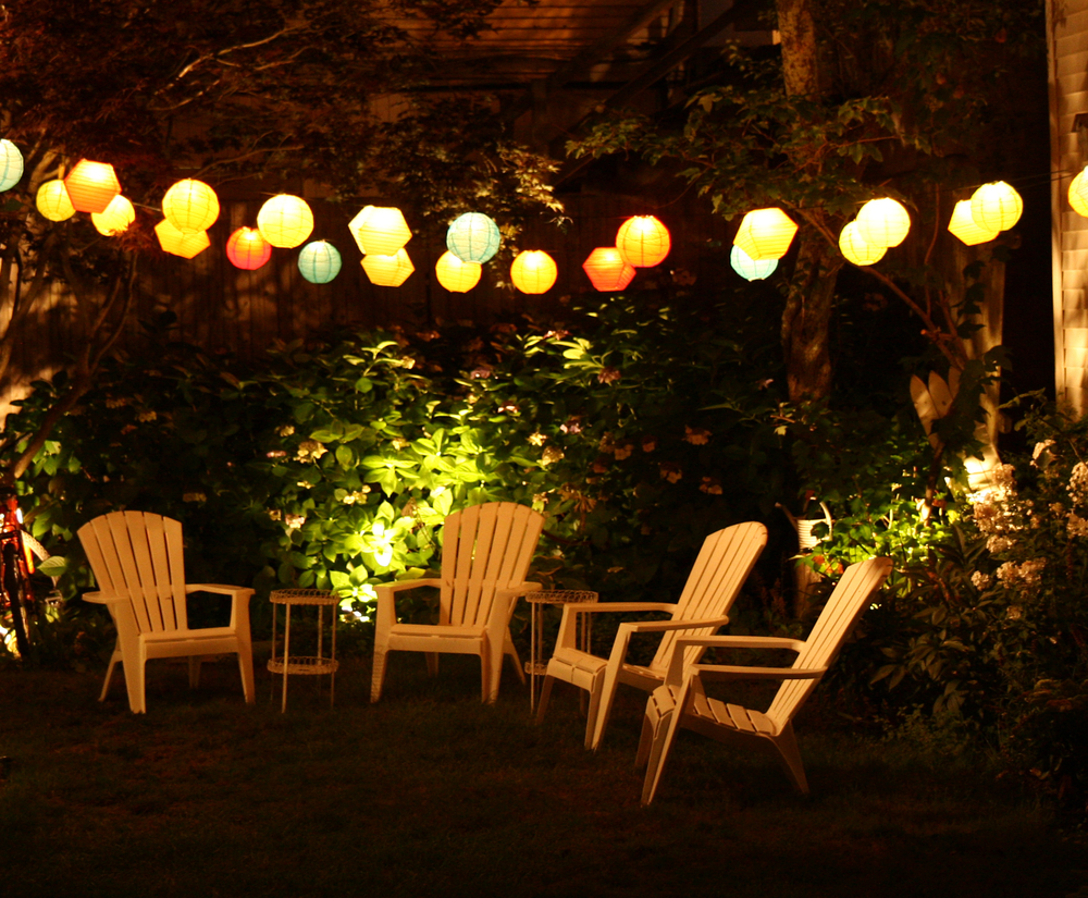 An inviting backyard space with lawn chairs and lighting