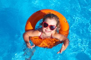 She's practicing pool safety with her safety float!