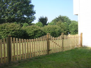 A scalloped wooden picket fence